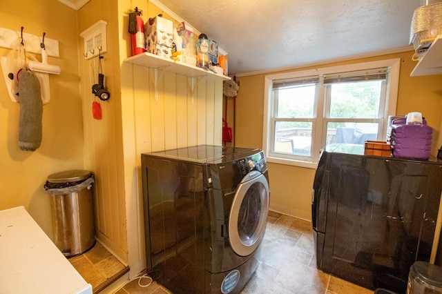 laundry area with washer and clothes dryer, crown molding, and baseboards