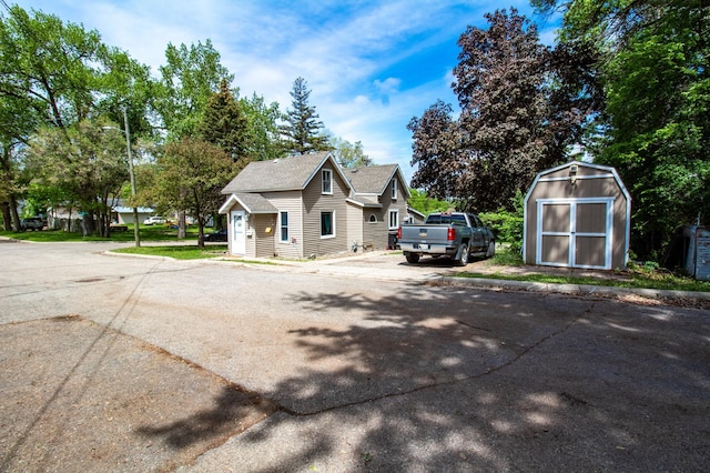 view of property exterior with a storage unit and an outbuilding