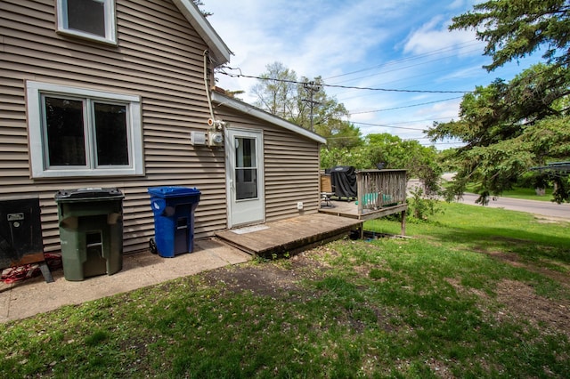 view of green lawn with a wooden deck