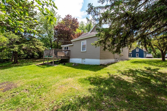 view of grassy yard featuring a wooden deck