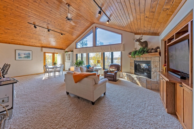 36737 Shoreview Dr, Wabana Twp, MN 55744 - carpeted living room with rail lighting, wood ceiling, a stone fireplace, baseboards, and high vaulted ceiling