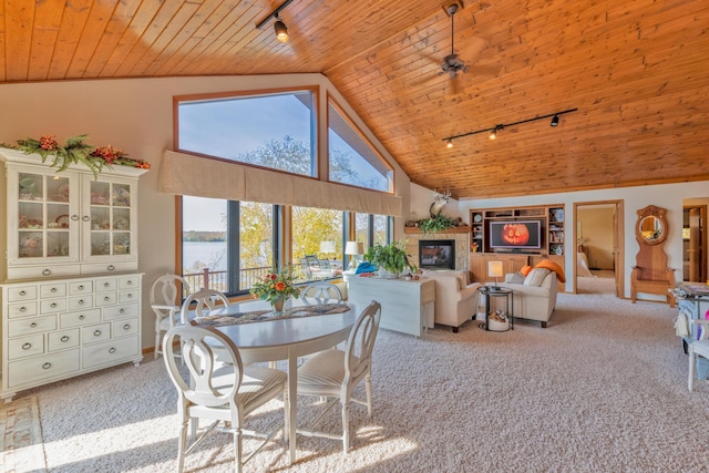 36737 Shoreview Dr, Wabana Twp, MN 55744 - dining room with track lighting, wooden ceiling, light carpet, high vaulted ceiling, and a glass covered fireplace