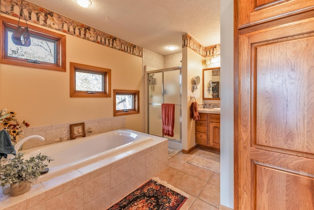 36737 Shoreview Dr, Wabana Twp, MN 55744 - bathroom featuring vanity, a textured ceiling, a stall shower, a garden tub, and tile patterned flooring