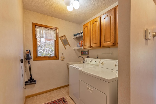 36737 Shoreview Dr, Wabana Twp, MN 55744 - washroom with cabinet space, washing machine and dryer, a textured ceiling, light tile patterned flooring, and baseboards