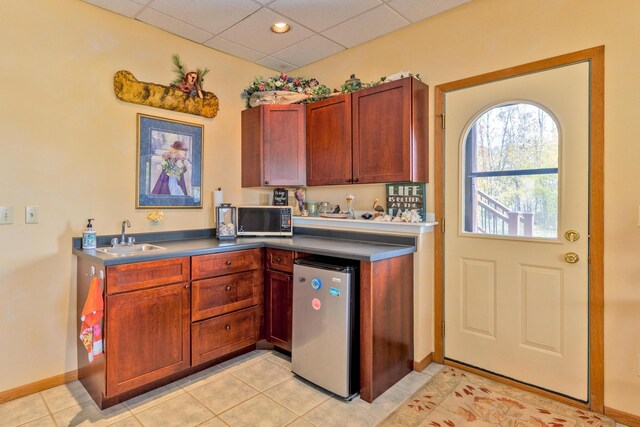 36737 Shoreview Dr, Wabana Twp, MN 55744 - kitchen with a sink, refrigerator, a drop ceiling, light tile patterned floors, and baseboards