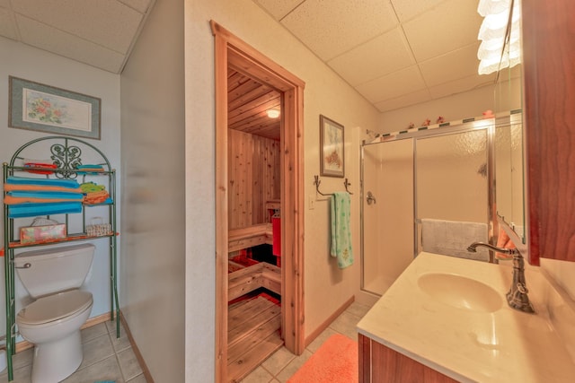 36737 Shoreview Dr, Wabana Twp, MN 55744 - bathroom featuring tile patterned flooring, a drop ceiling, vanity, toilet, and a stall shower