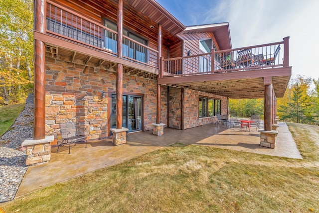 36737 Shoreview Dr, Wabana Twp, MN 55744 - back of property featuring a balcony, stone siding, a patio area, and a lawn
