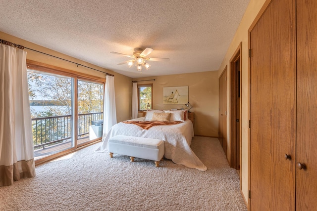 36737 Shoreview Dr, Wabana Twp, MN 55744 - bedroom featuring access to exterior, light carpet, a textured ceiling, and ceiling fan