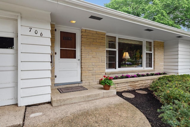 706 9th Ave SW, Faribault, MN 55021 - doorway to property featuring stone siding