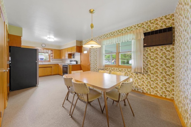 706 9th Ave SW, Faribault, MN 55021 - dining area with wallpapered walls, plenty of natural light, light colored carpet, and baseboards
