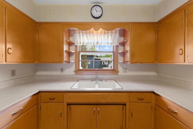 706 9th Ave SW, Faribault, MN 55021 - kitchen featuring open shelves, a sink, light countertops, and wallpapered walls