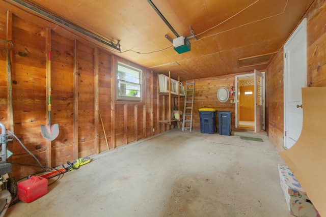 706 9th Ave SW, Faribault, MN 55021 - garage featuring wood walls and a garage door opener