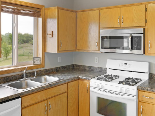 11023 171st Ave SE, Becker, MN 55308 - kitchen featuring white appliances, a sink, and dark countertops