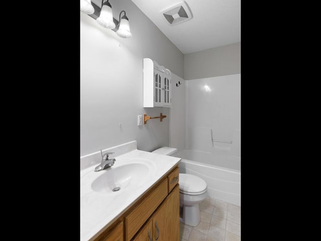 11023 171st Ave SE, Becker, MN 55308 - full bathroom featuring toilet, vanity, bathtub / shower combination, and tile patterned flooring