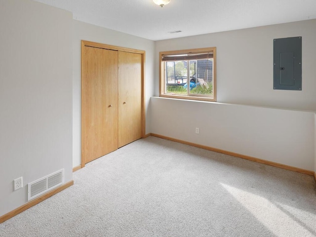 11023 171st Ave SE, Becker, MN 55308 - unfurnished bedroom featuring electric panel, light carpet, a closet, and baseboards