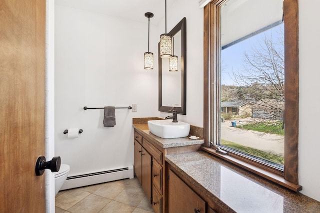 7012 Sally Ln, Edina, MN 55439 - bathroom featuring a baseboard radiator, vanity, and toilet