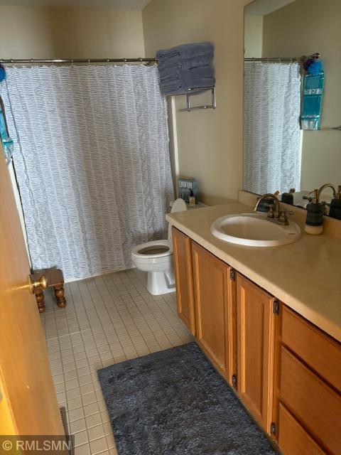 8012 Par Five Dr, South Harbor Twp, MN 56359 - full bathroom with tile patterned floors, vanity, and toilet