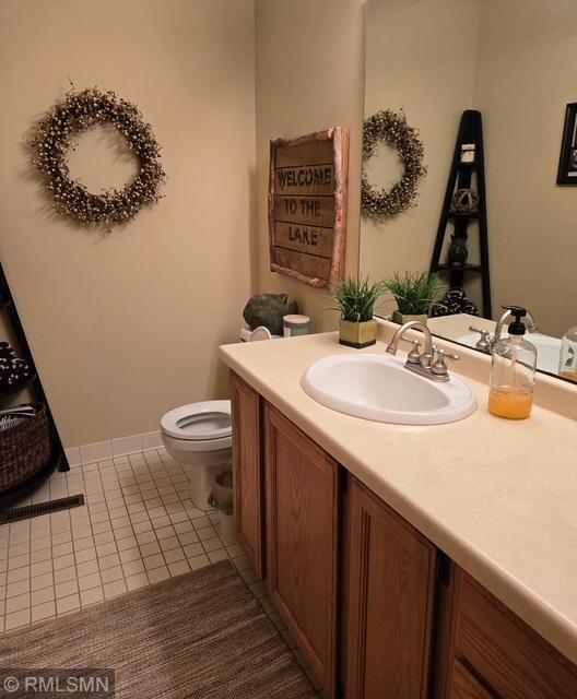 8012 Par Five Dr, South Harbor Twp, MN 56359 - bathroom with tile patterned flooring, vanity, and toilet