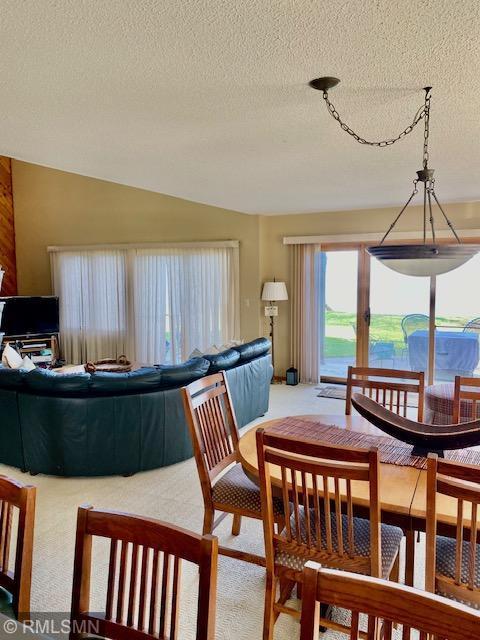 8012 Par Five Dr, South Harbor Twp, MN 56359 - carpeted dining space featuring a textured ceiling