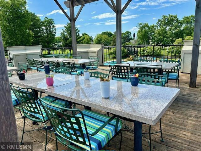 8012 Par Five Dr, South Harbor Twp, MN 56359 - wooden deck with outdoor dining area and view of scattered trees