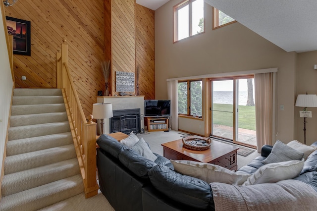 8012 Par Five Dr, South Harbor Twp, MN 56359 - living area featuring light carpet, plenty of natural light, a towering ceiling, stairway, and a fireplace