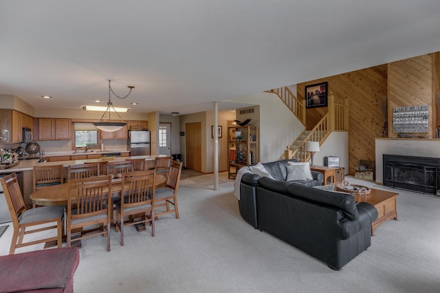 8012 Par Five Dr, South Harbor Twp, MN 56359 - living room featuring light carpet, wooden walls, stairway, a fireplace, and recessed lighting