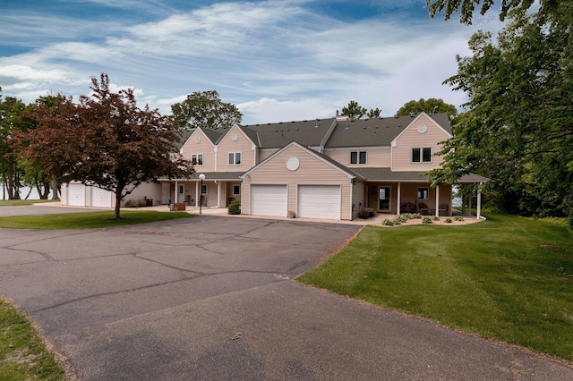 8012 Par Five Dr, South Harbor Twp, MN 56359 - view of front of home featuring covered porch, a front yard, a garage, and asphalt driveway