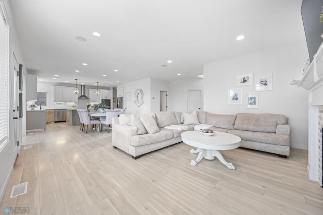 508 13th St NE, Dilworth, MN 56529 - living room featuring light wood-type flooring, recessed lighting, and a fireplace