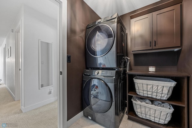 508 13th St NE, Dilworth, MN 56529 - washroom featuring stacked washer / drying machine, baseboards, cabinet space, and light colored carpet