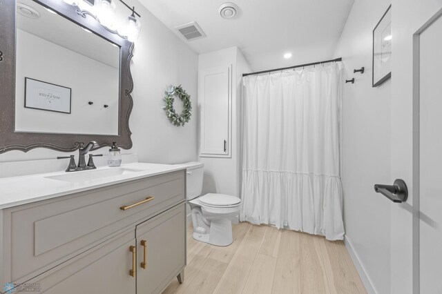 508 13th St NE, Dilworth, MN 56529 - bathroom with wood finished floors, vanity, toilet, a shower with shower curtain, and baseboards