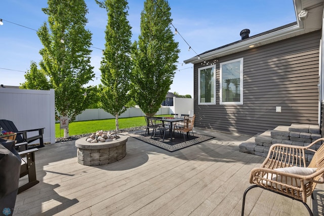 508 13th St NE, Dilworth, MN 56529 - wooden terrace featuring a fenced backyard, a fire pit, and outdoor dining space