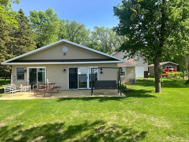 39307 Clearmont Rd, Everts Twp, MN 56515 - back of property with a patio area and a yard