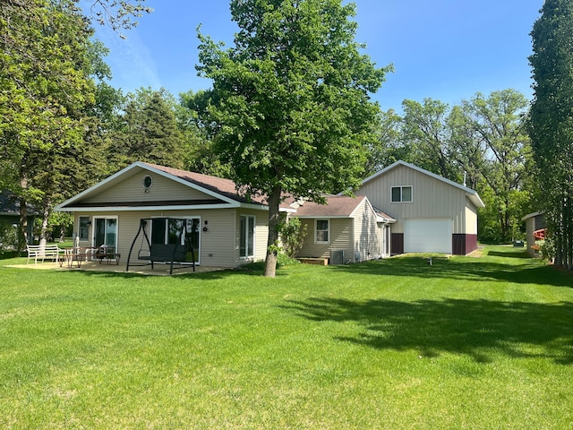 39307 Clearmont Rd, Everts Twp, MN 56515 - back of house featuring a detached garage, cooling unit, a yard, and a patio area