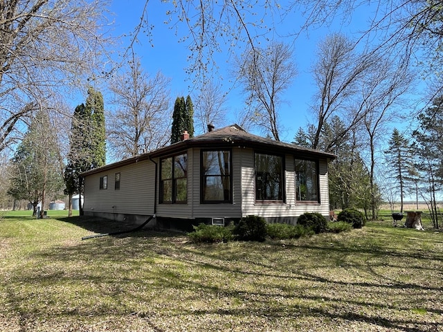 37165 300th Ave NE, Rollis Twp, MN 56724 - view of side of home with a lawn and a chimney
