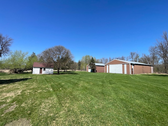 37165 300th Ave NE, Rollis Twp, MN 56724 - view of grassy yard featuring a pole building and an outdoor structure
