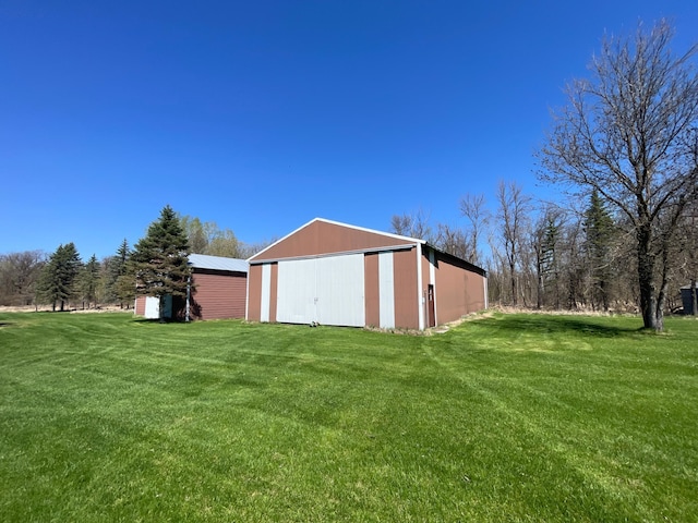 37165 300th Ave NE, Rollis Twp, MN 56724 - view of green lawn with a pole building and an outdoor structure