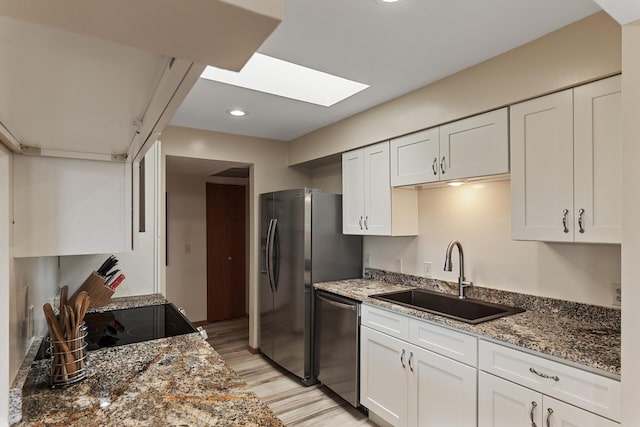 14575 Burma Ave W Unit 306, Rosemount, MN 55068 - kitchen with a sink, appliances with stainless steel finishes, light wood finished floors, a skylight, and white cabinets