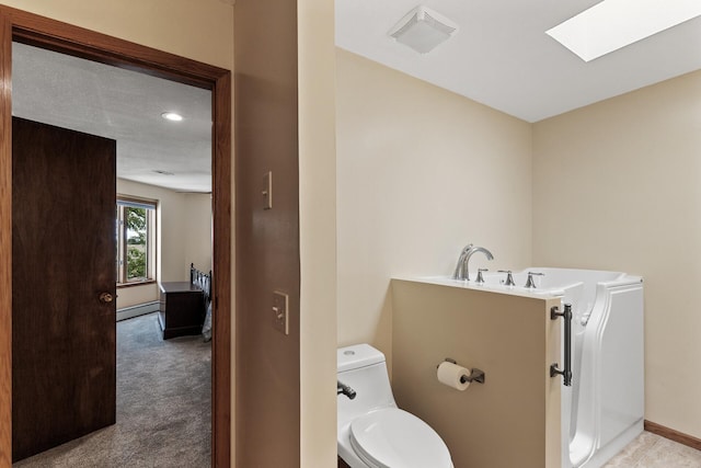 14575 Burma Ave W Unit 306, Rosemount, MN 55068 - bathroom featuring a baseboard radiator, a skylight, toilet, and baseboards