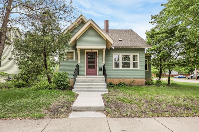 727 10th Ave N, Saint Cloud, MN 56303 - bungalow-style home featuring a chimney and a shingled roof