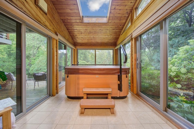 sunroom featuring a jacuzzi, vaulted ceiling, a skylight, tile patterned flooring, and wooden ceiling