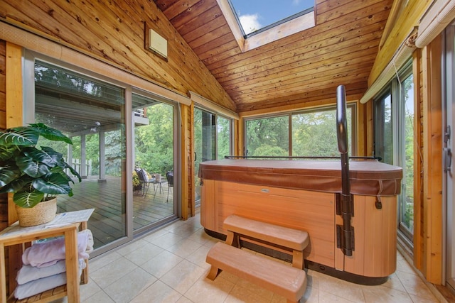 sunroom / solarium with a hot tub, tile patterned floors, lofted ceiling, a skylight, and wooden ceiling