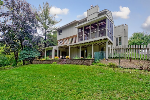 back of property featuring a sunroom and a chimney