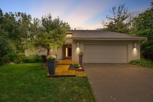 view of front facade with an attached garage, driveway, and a front yard