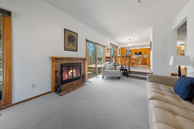 carpeted living area with a fireplace with flush hearth and baseboards