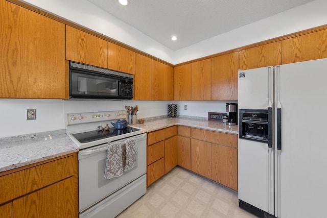 kitchen featuring white appliances, light floors, light stone countertops, brown cabinets, and recessed lighting
