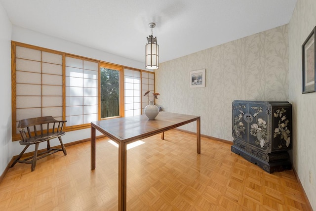 dining area with wallpapered walls and baseboards