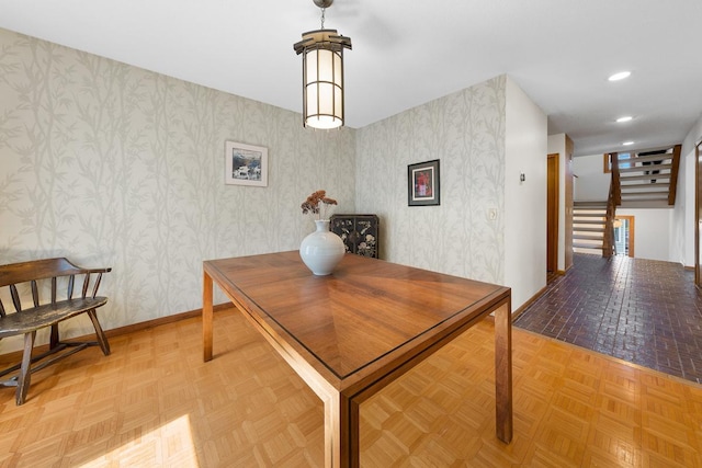 dining area with wallpapered walls, stairs, baseboards, and recessed lighting