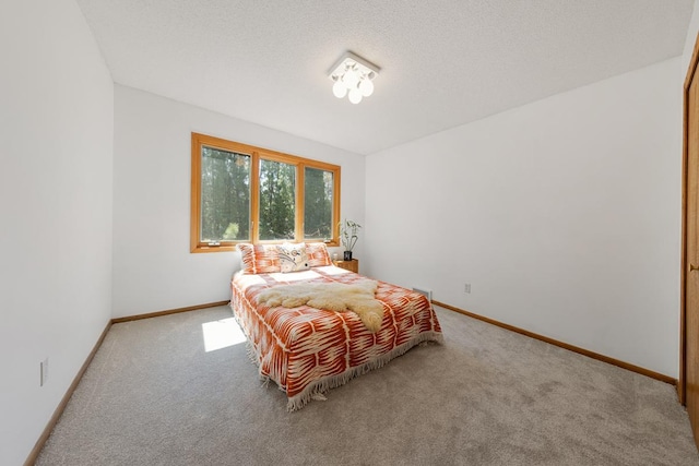 bedroom with carpet floors and baseboards