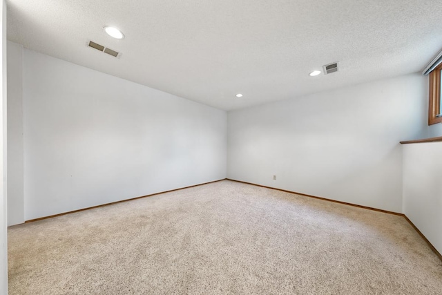 carpeted spare room featuring recessed lighting and baseboards
