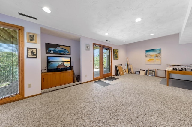 unfurnished living room featuring baseboards, carpet flooring, and recessed lighting